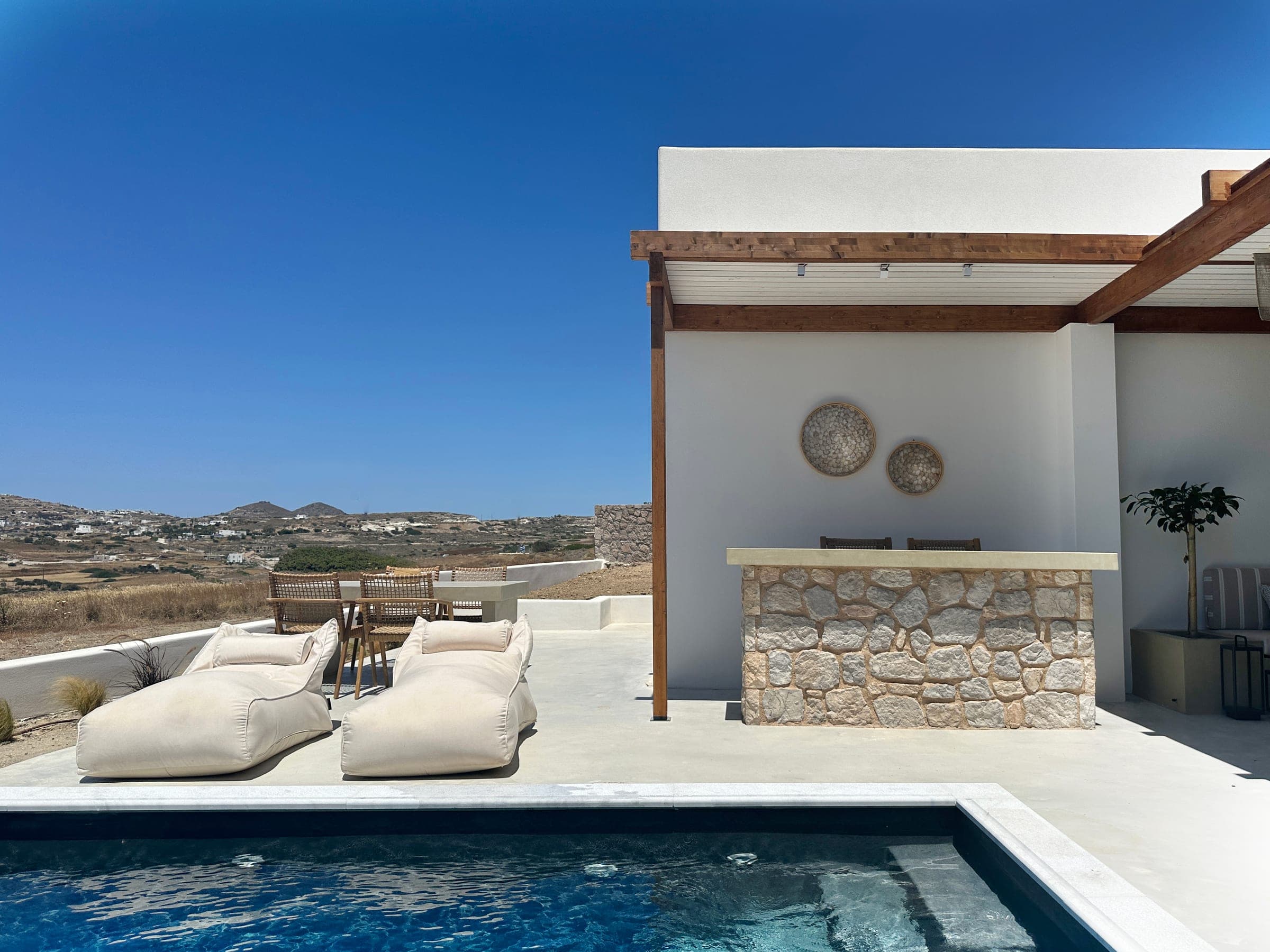 Pool terrace and pergola looking over Adamas bay